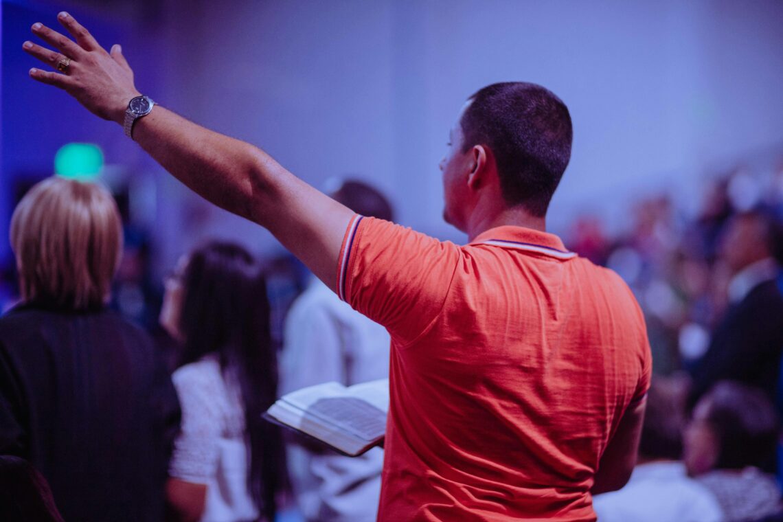 man praising God in Church