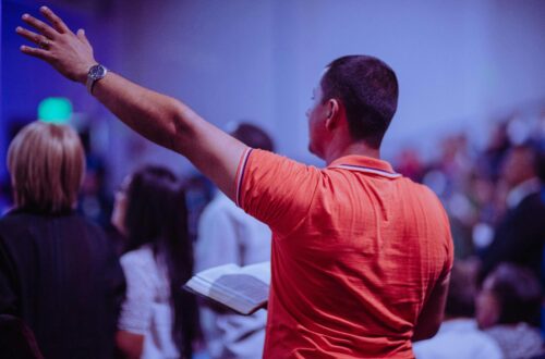 man praising God in Church