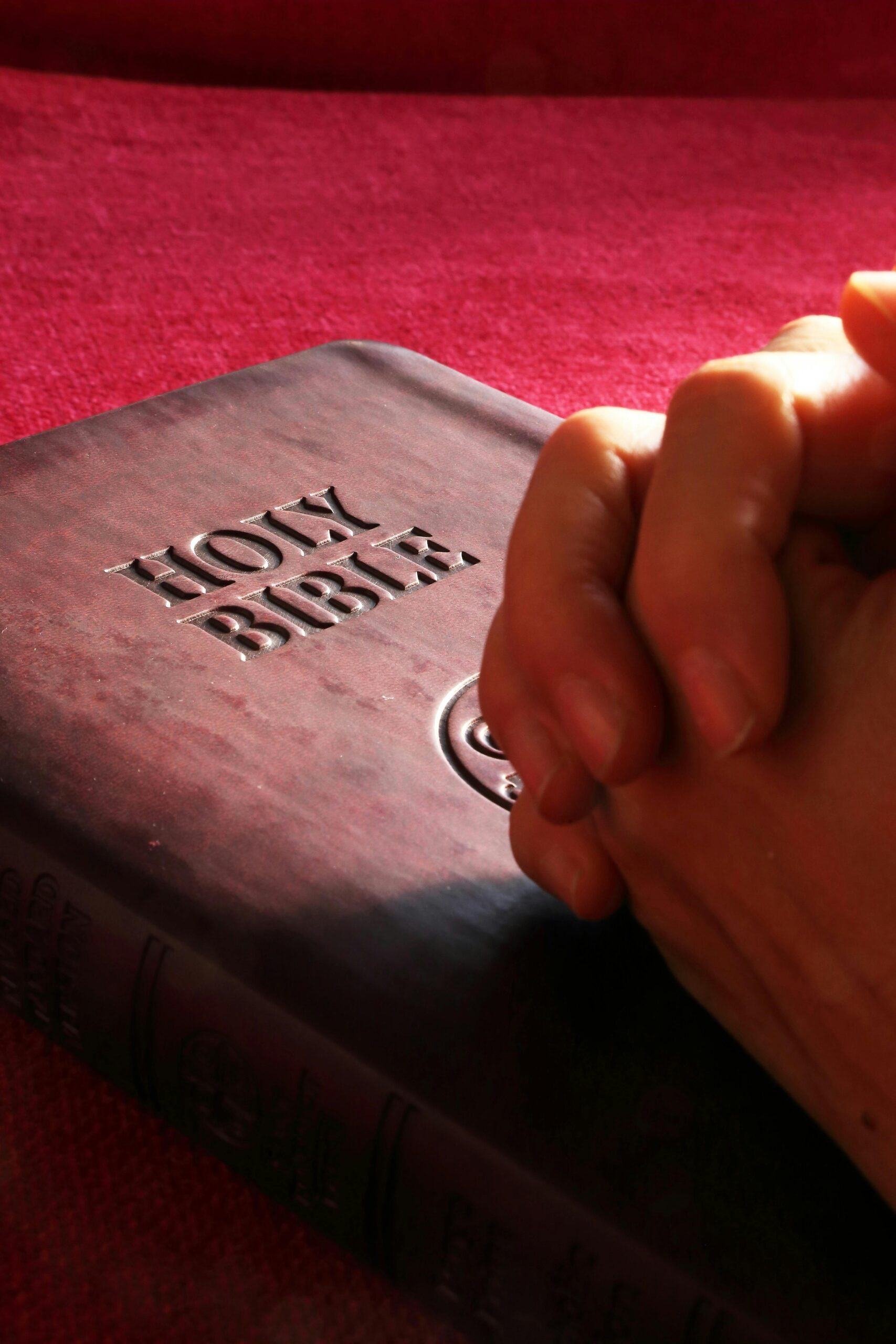 man praying on the bible