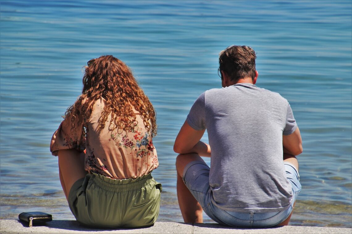 a couple sitting at the beach