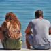 a couple sitting at the beach