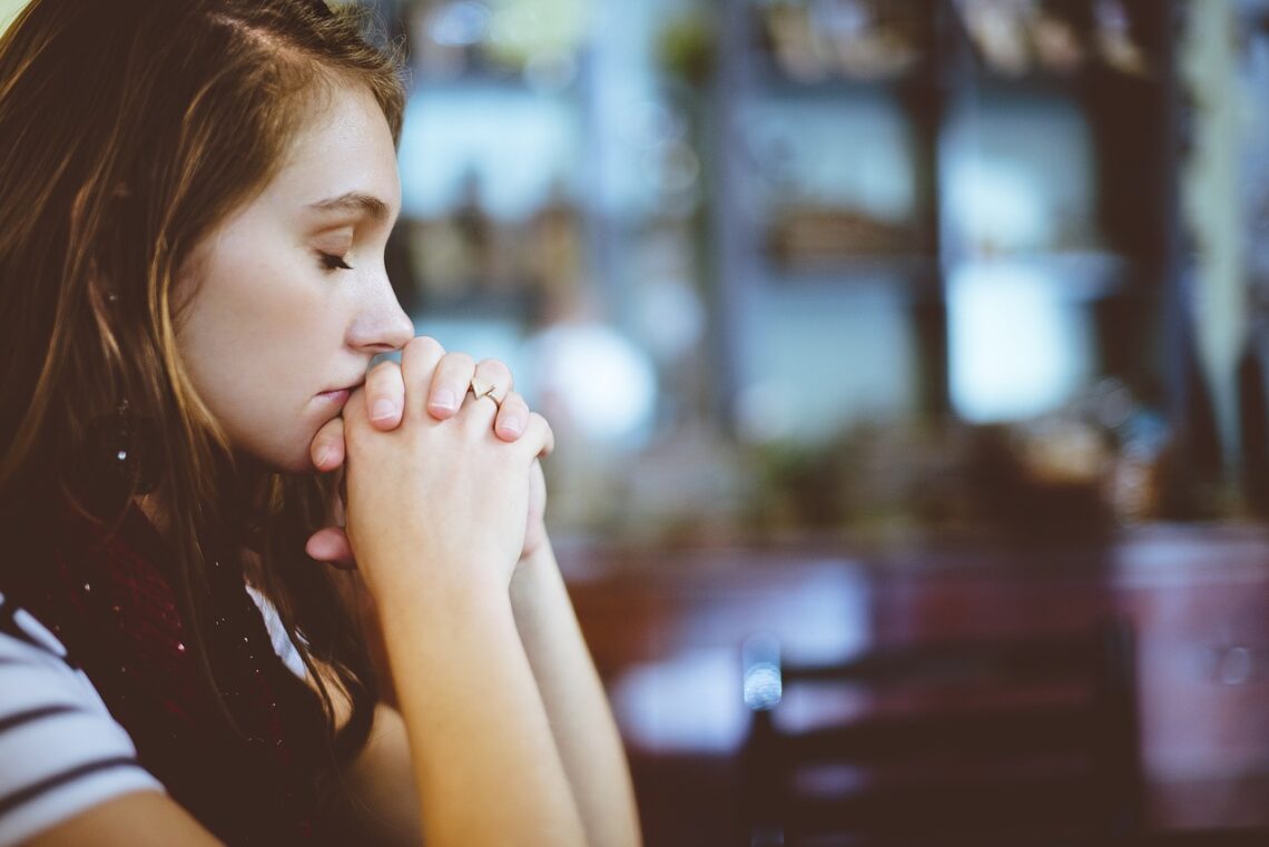 a woman praying in church