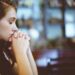 a woman praying in church