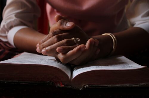 a woman praying using her bible