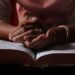 a woman praying using her bible