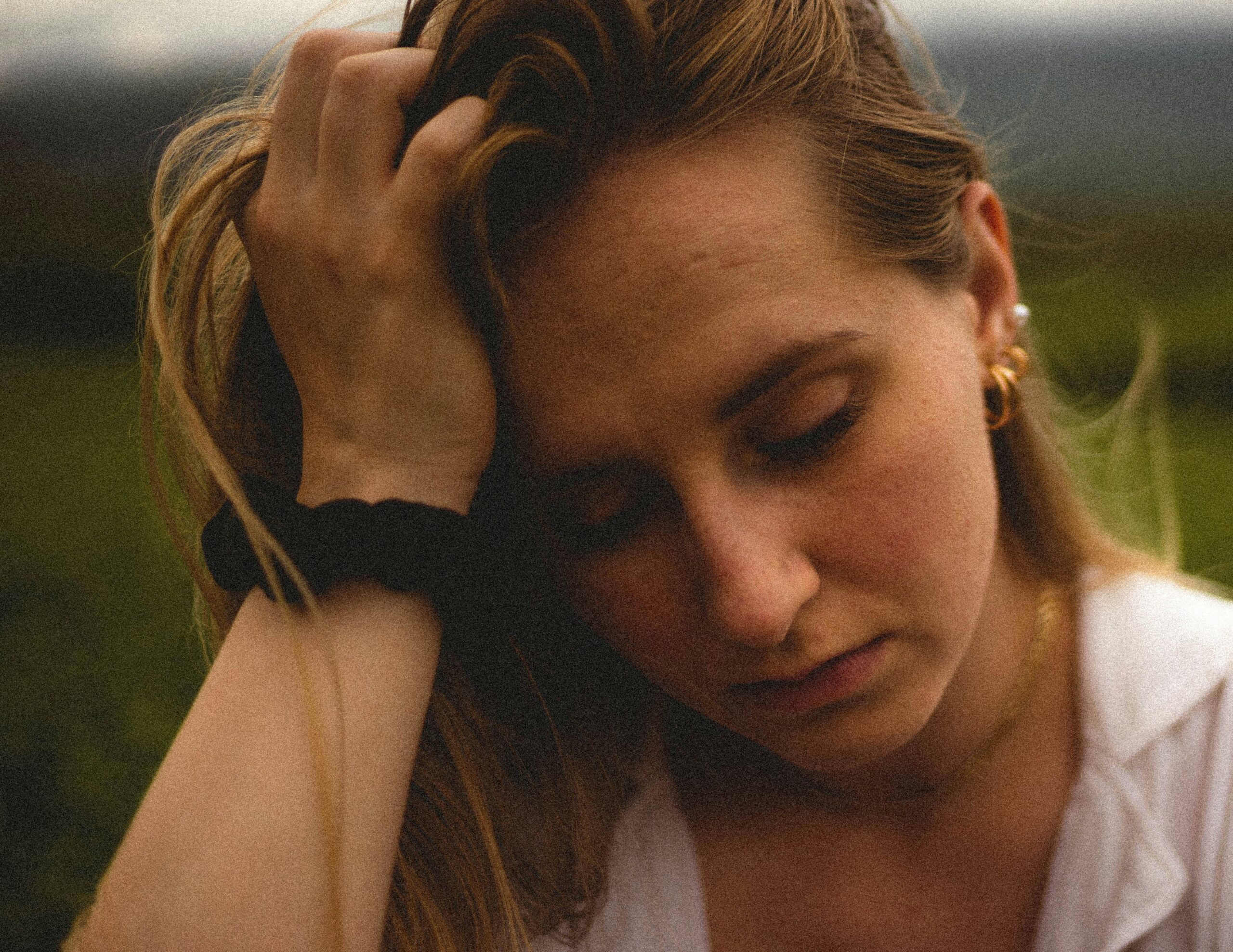 a worried woman sitting on the ground