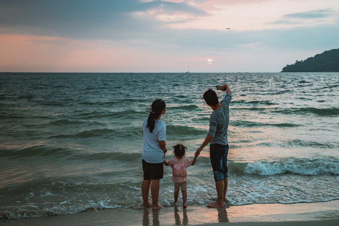 family hanging out at the beach